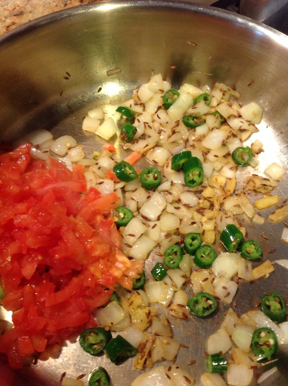 After the onions turn translucent, add the diced tomatoes.  Mix & cover for 3 mins on medium flame.
