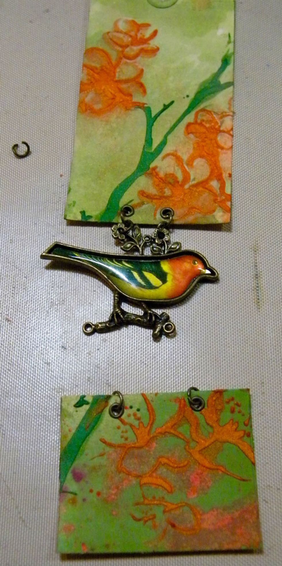 After the paint dried, I cut one of the tags smaller and added the bird to connect them using jewelry jump rings.