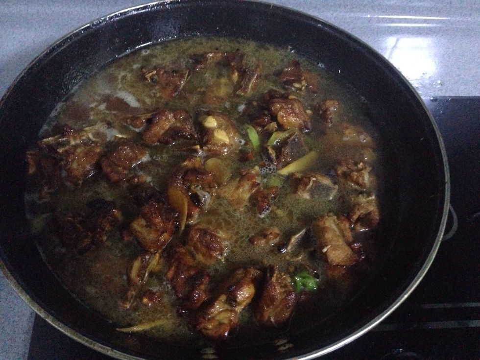 After the pork became dark color, add hot water.