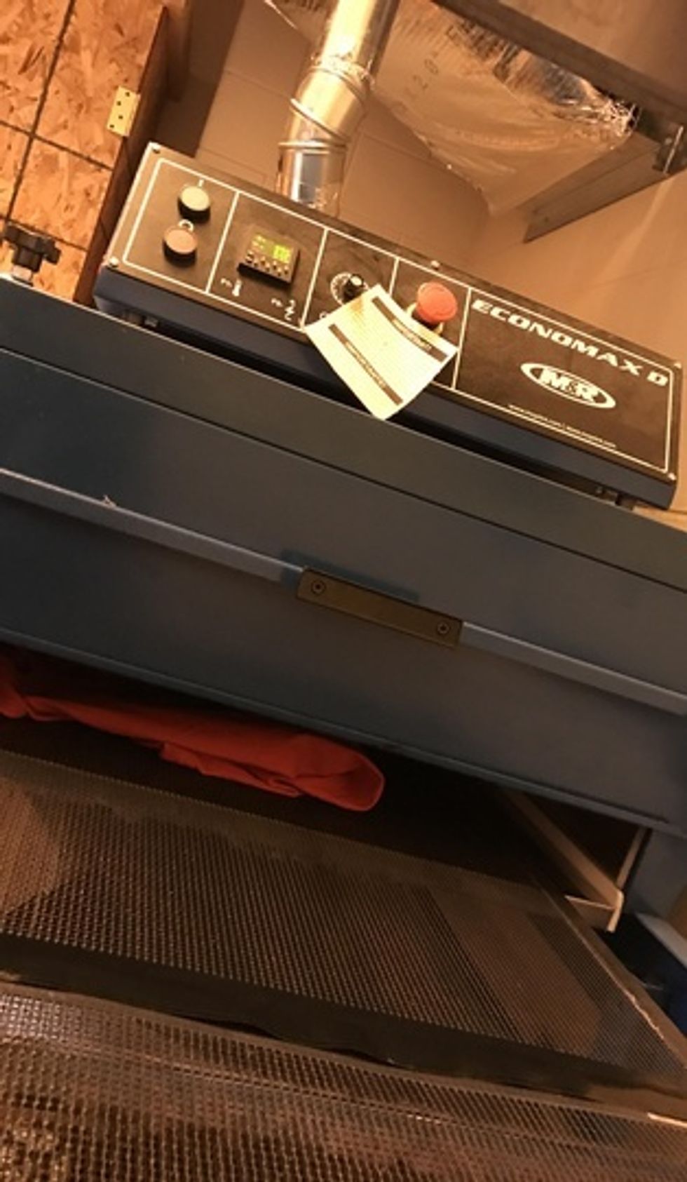 After the practice shirt has the ink on it, put it in the dryer. Make sure the dryer is at 975. Check the practice shirt after it comes out to see if it turned out ok.