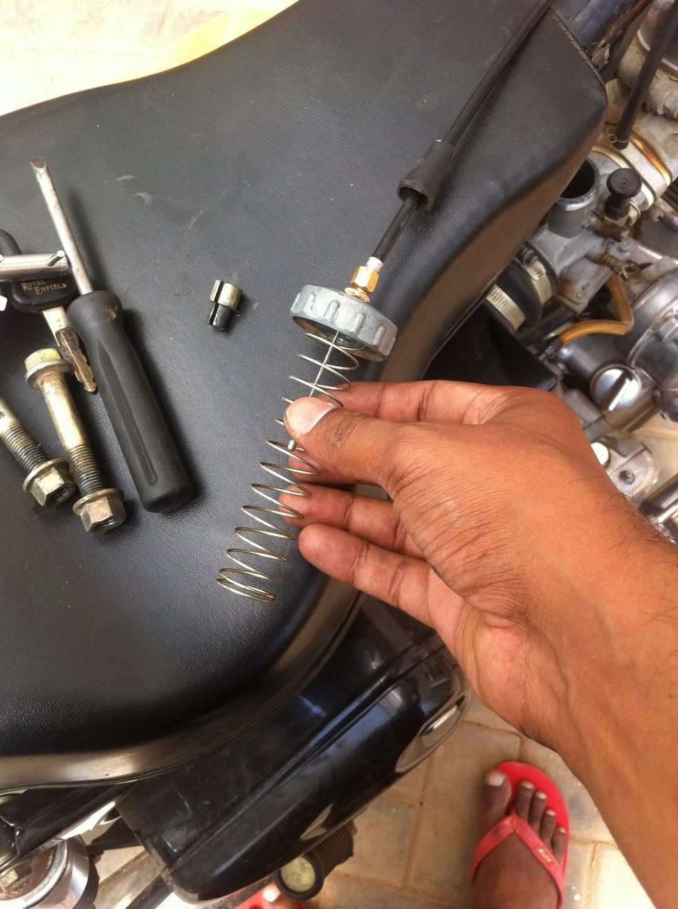 After the rubber gasket the spring is inserted.