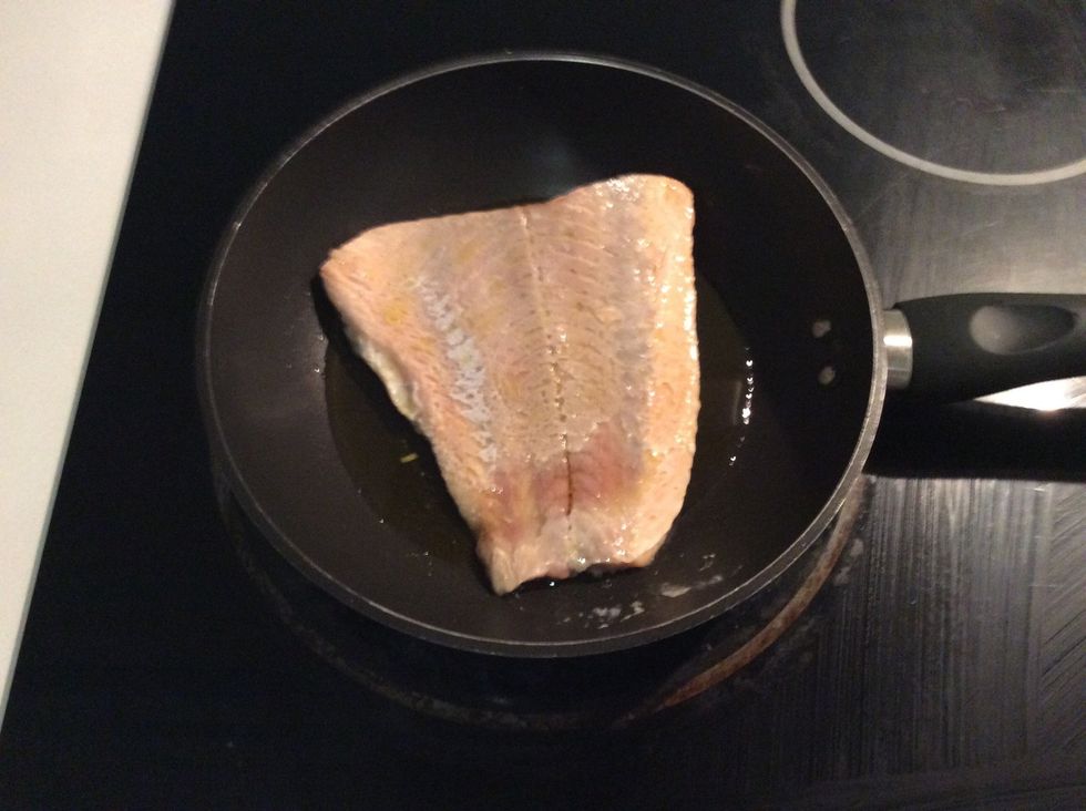 After the salmon has been cooking for 4 to 5 minutes flip it over.