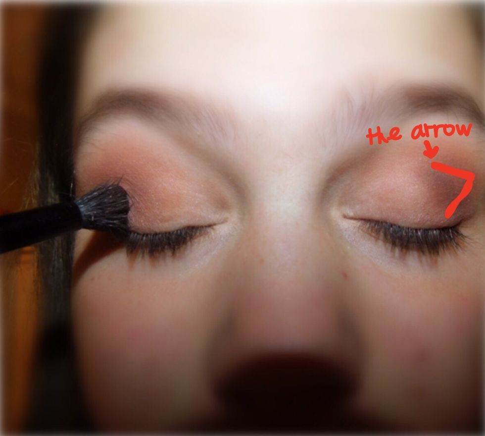 After the second color, take a dark color, usually brown, and tap a little of it into your blending brush. Make a small arrow on the end of your crease, to create dimension.