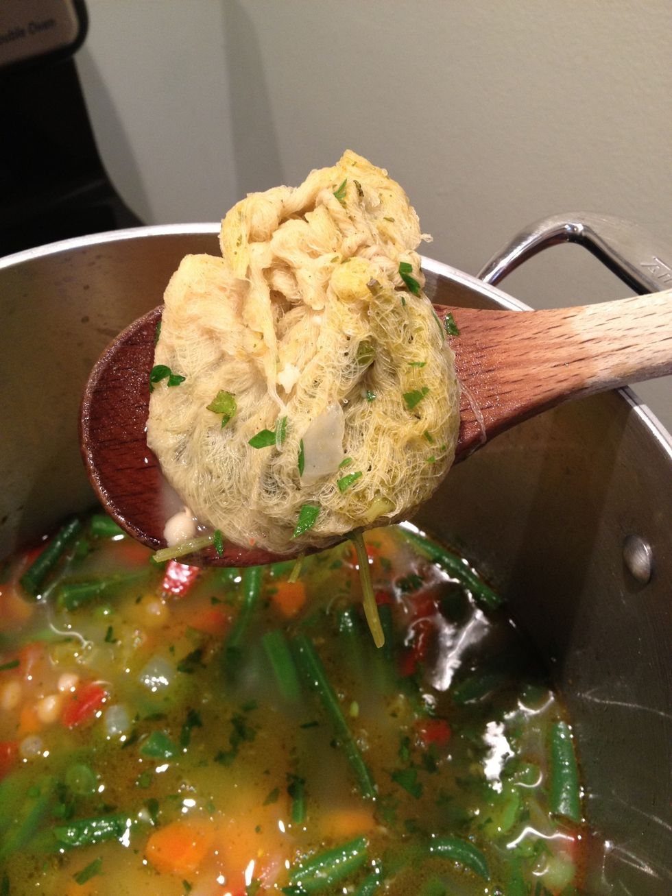 After the soup had finished simmering, add the favas and the green beans to the pot. Remove the bouquet garni.