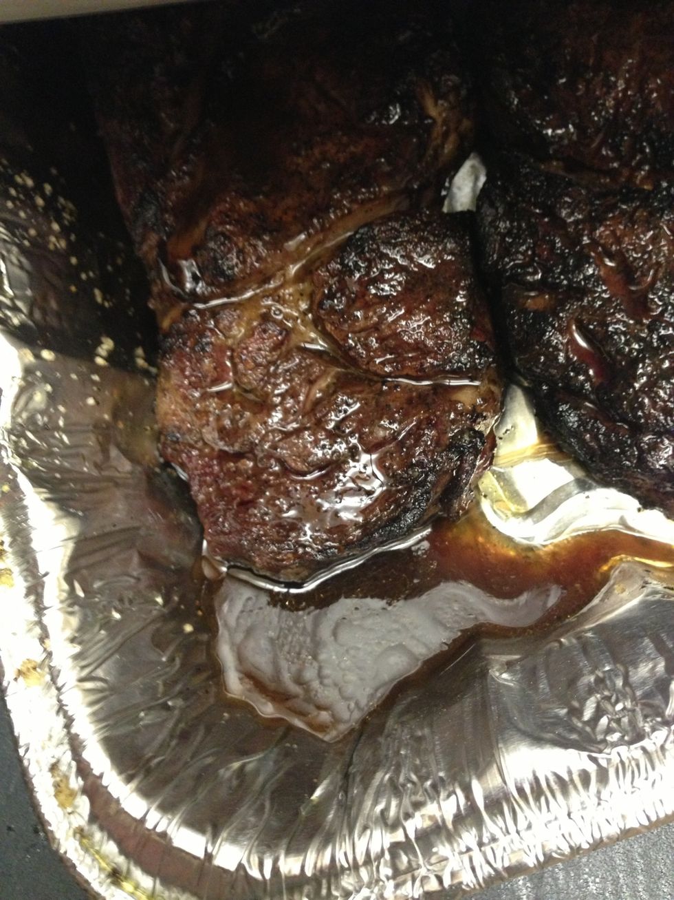 After the steaks are done, spoon in some of the drippings into the reduction sauce. 4-5 tablespoons is enough. Immediately return foil cover and allow steaks to rest.