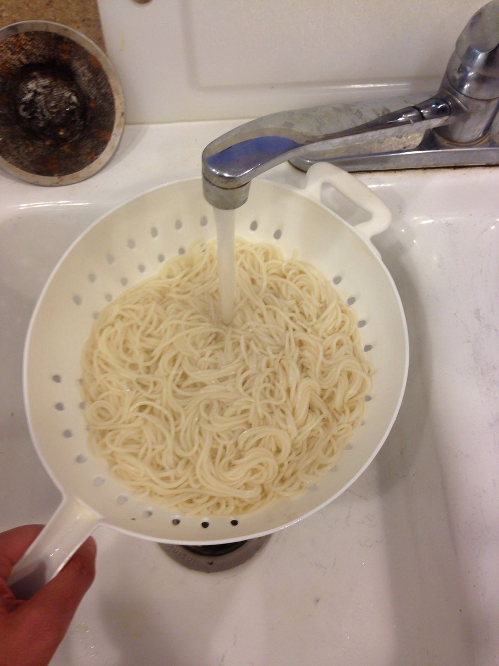 After the timer goes off, taste a noodle. If it's to your liking, strain the noodles and run cold water over them. Set the noodles aside while you prepare the other ingredients.