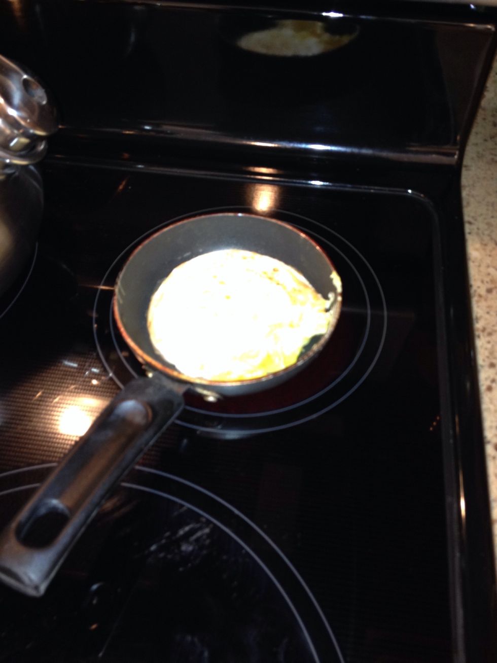 After the top of the egg cooks all the way over, flip your egg using a spatula!