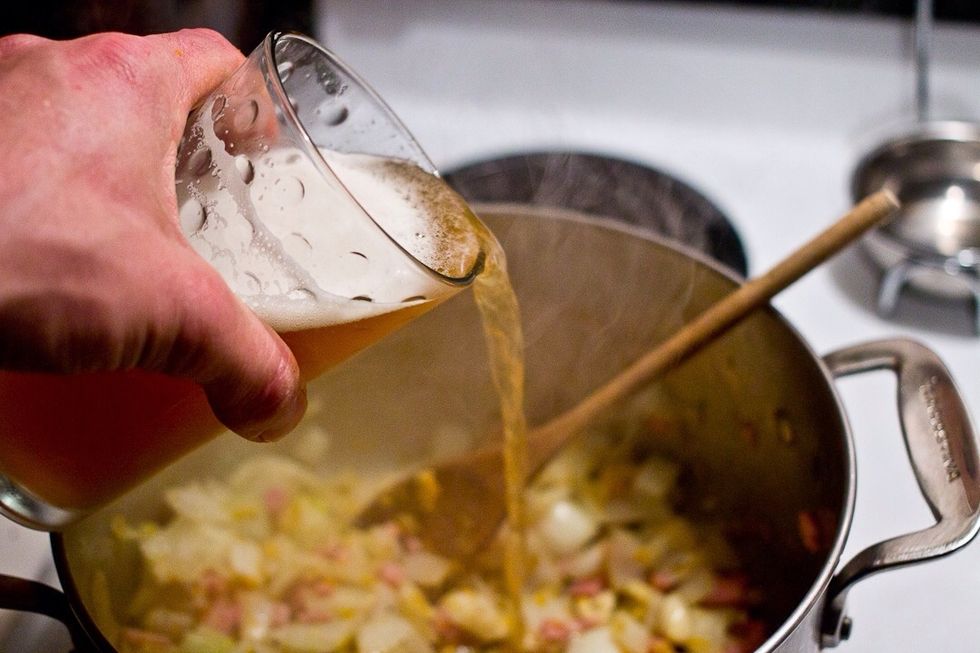 After the veg has softened and everything is hot and sweaty, cool it down with the beer. (In other words, deglaze the pan)