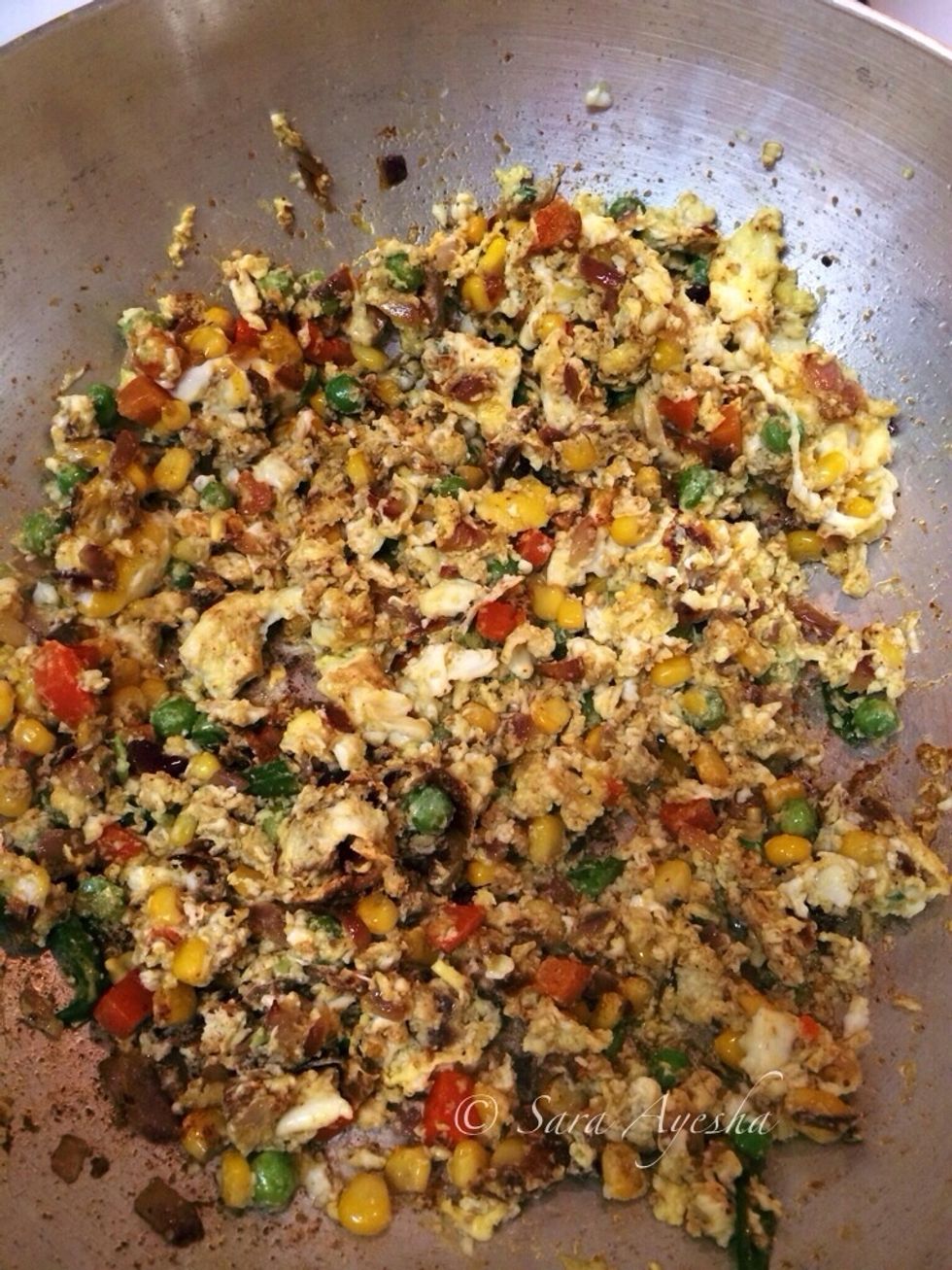 After the veg is nice and tender. Cumin, coriander and Garam masala powder are tossed in and fried a bit to get the smell. add your eggs and scramble it, don't forget salt in veg.