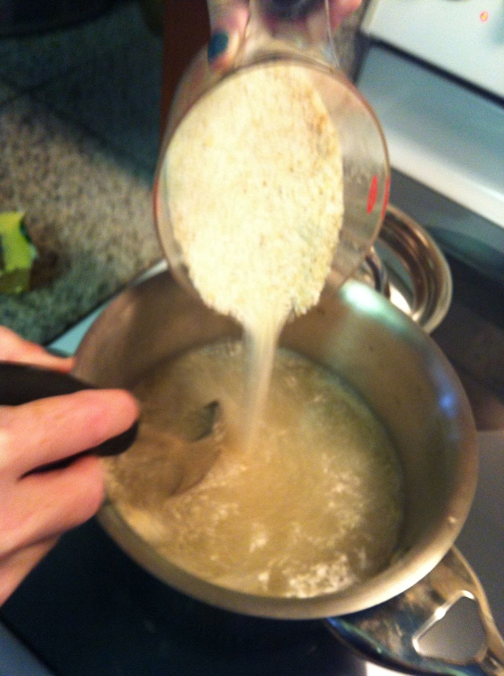 After the water reaches a boil, slowly stir the grits into the saucepan. Once you've added all of the grits, return the water to a boil and then immediately turn the heat down to low.