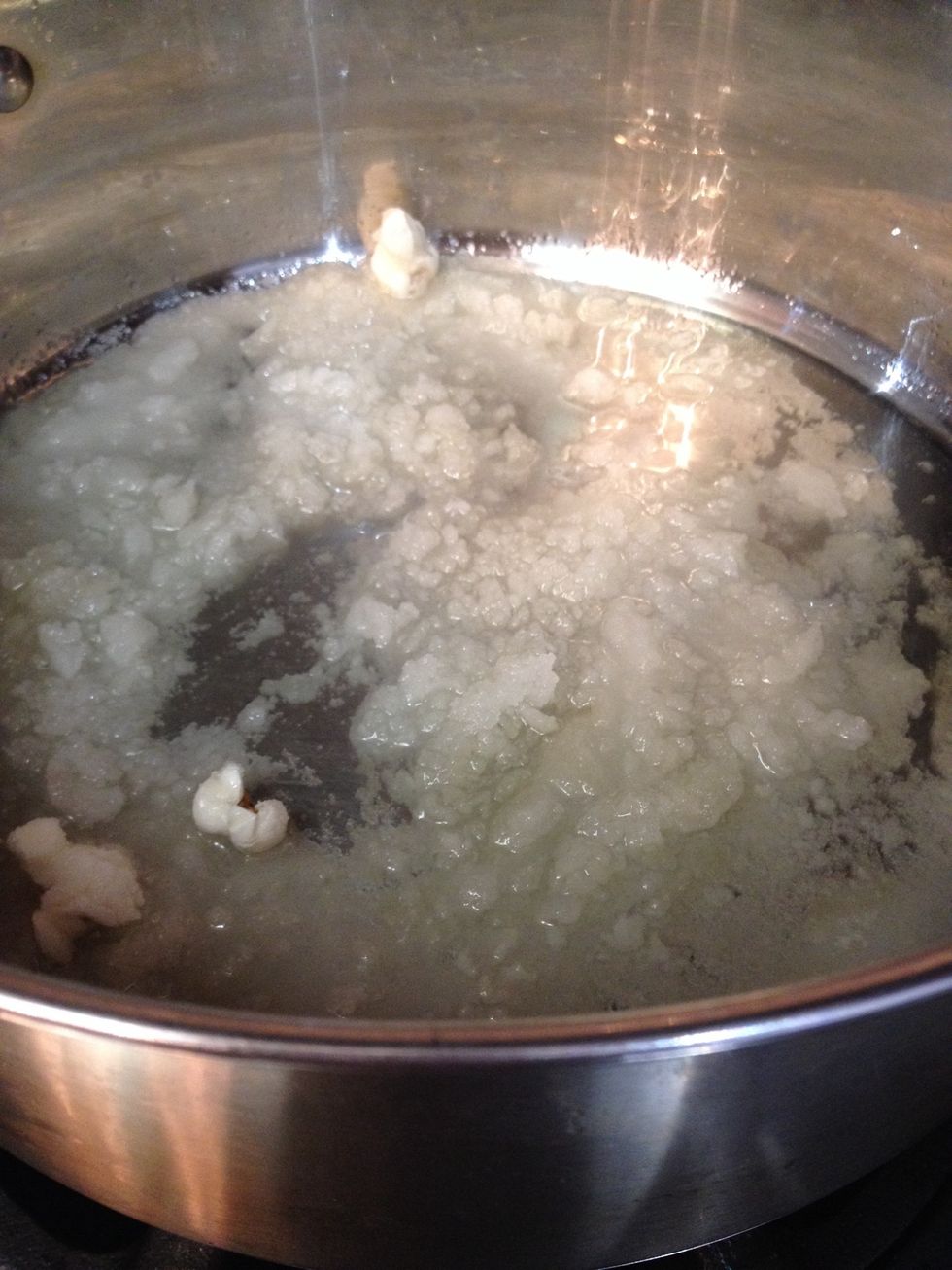 After they've popped, pour the sugar all over and give it a stir with a wooden spoon. Don't worry about any chunks.