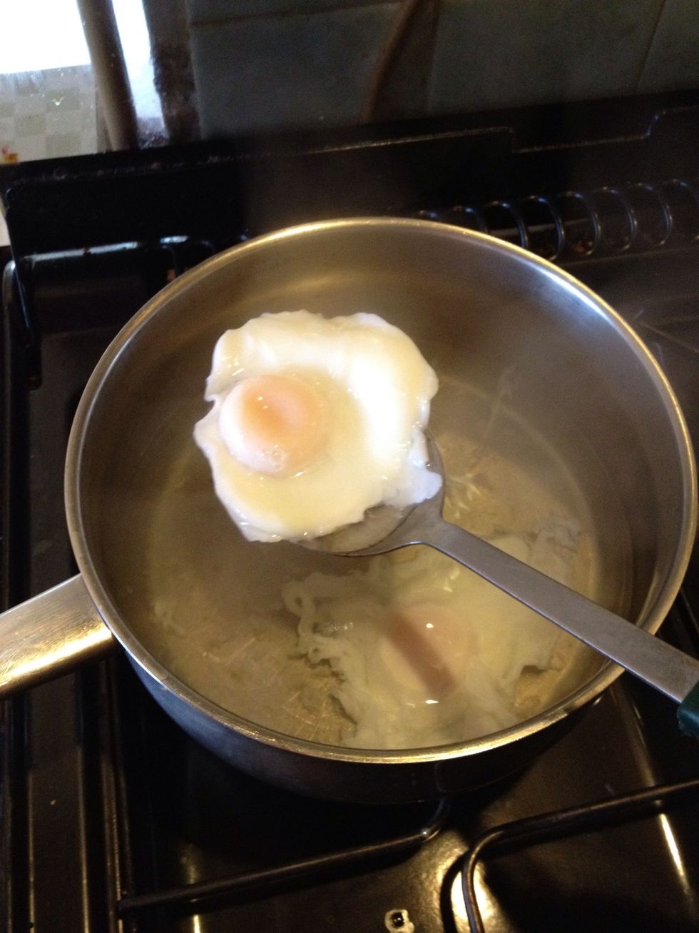 After three minutes, remove pan lid and using a slotted spoon, carefully remove the eggs and put them on buttered toast.