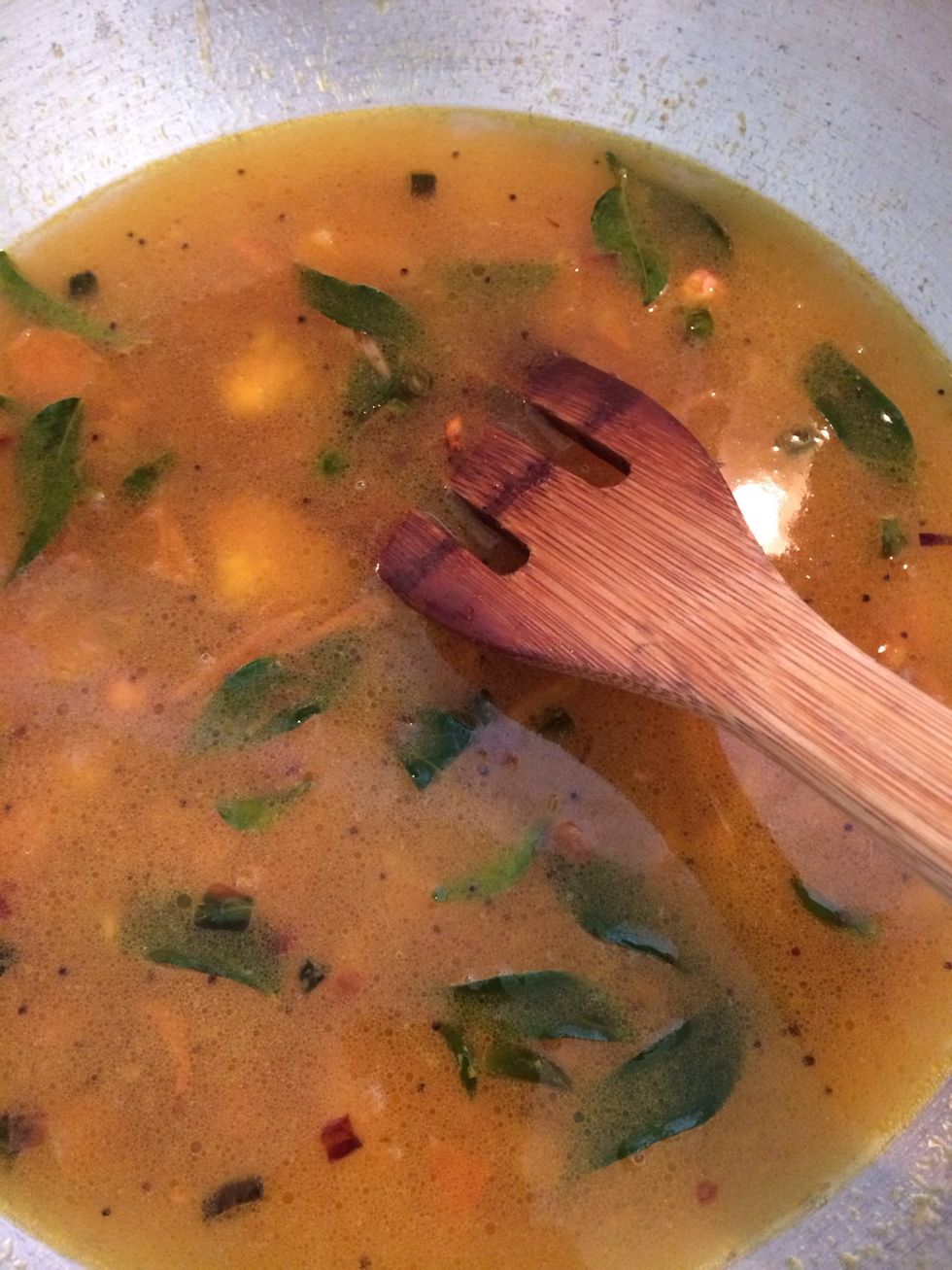 After tomatoes are cooked pour 2 cups of water. Not too much or it would be watery. Add curry leaves, cilantro and salt.