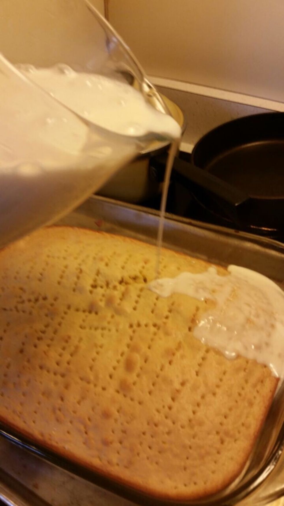 After tophe 1 to 2 hours take the cake out of the fridge and poke holes everywhere in it with a fork, start to pour milk little by little