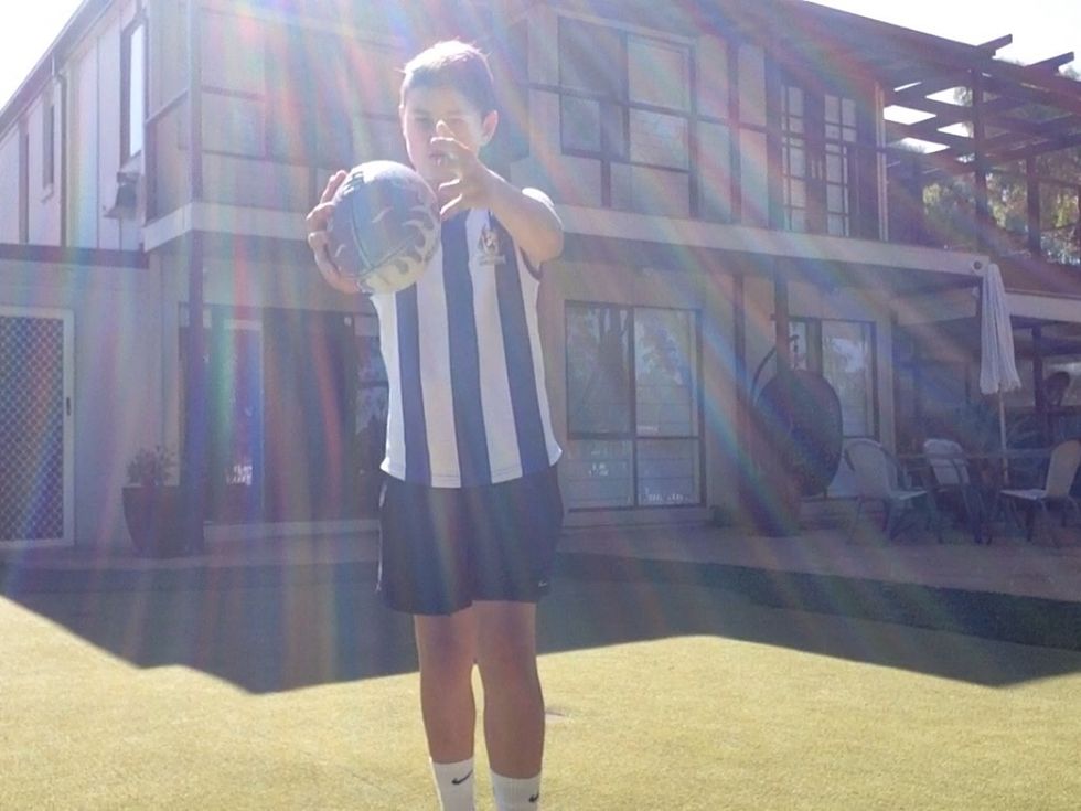 After u have done the grip u lift the ball up in the air as one of your feet come off the ground in time to kick the ball