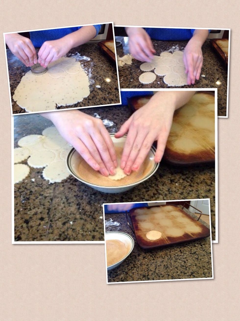 After, use the cookie cutter to cut the dough into small circles. Peel away excess dough and put the cookies in the cinnamon sugar mix. Ensure that the entire cookie is covered evenly. Place on stone.