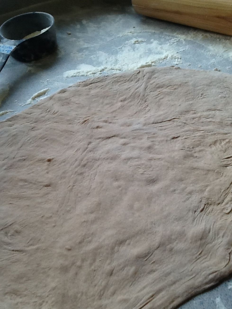 After, using a rolling pin, roll the dough into a circular shape.