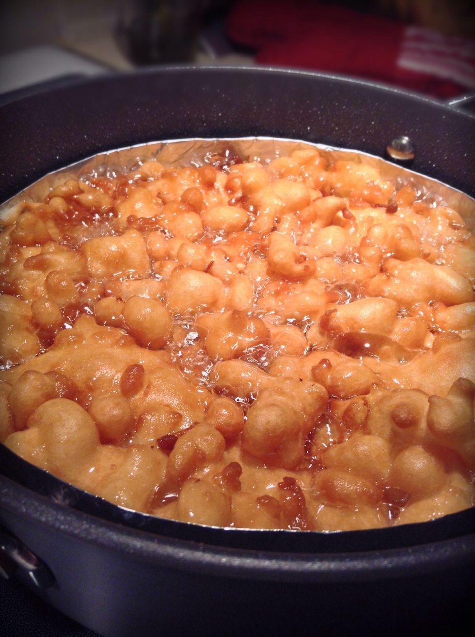 After waiting about 4 minutes flip your funnel cake by using your tongs and a wide spatula. Cook the funnel cake for another two minutes, place on a plate with paper towels to drain oil.