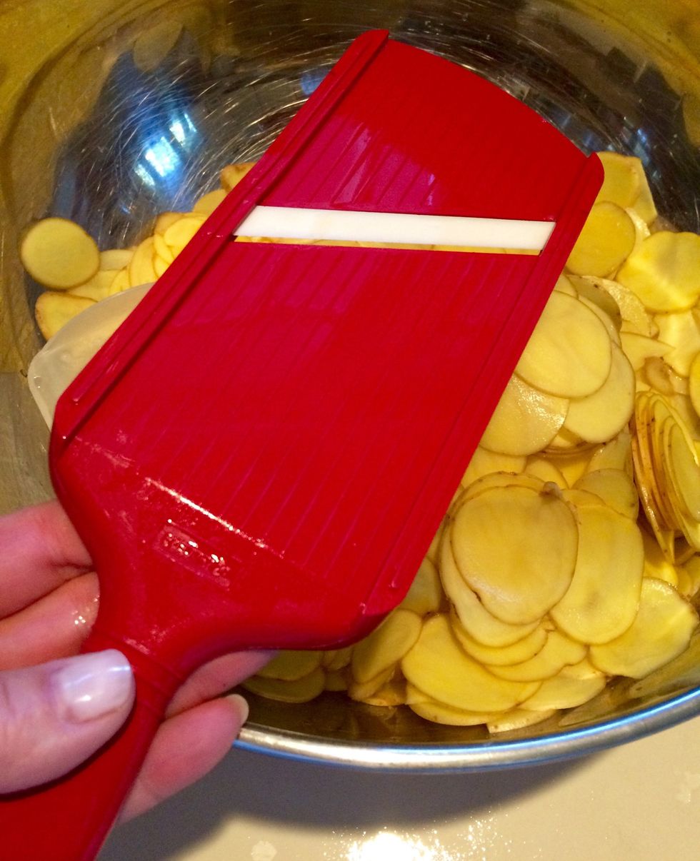 After washing the potatoes, no need to peel, thinly slice potatoes on a mandolin. Don't forget to use the guard! Faster yet, use your food processor, fitted with the slicing blade.