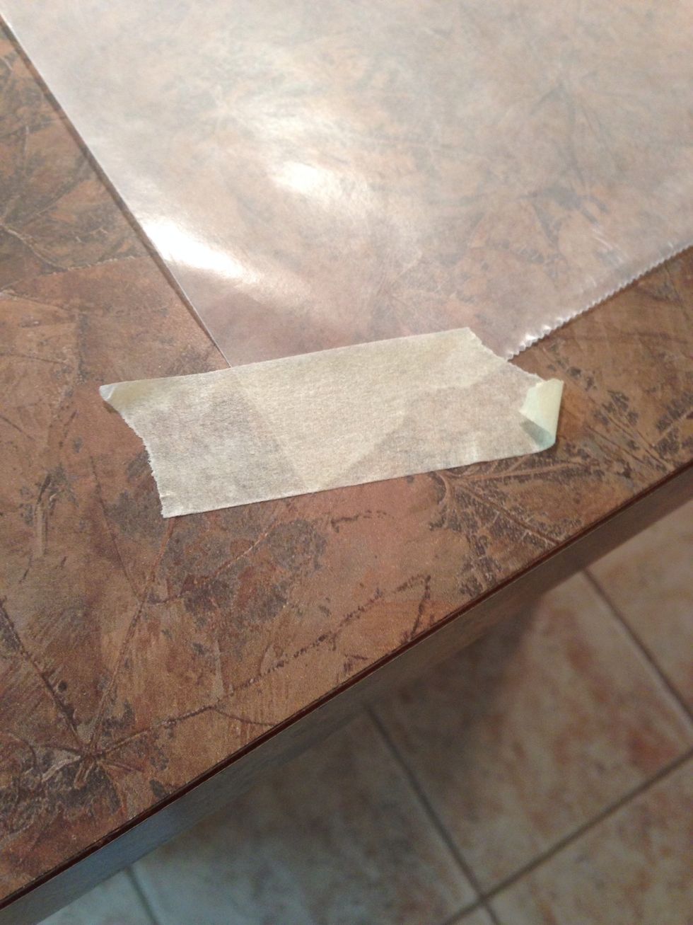 After years if having trouble keeping it still while I rolled, thinking tape wouldn't stick to wax paper, I just discovered masking tape works great to hold wax paper in place!