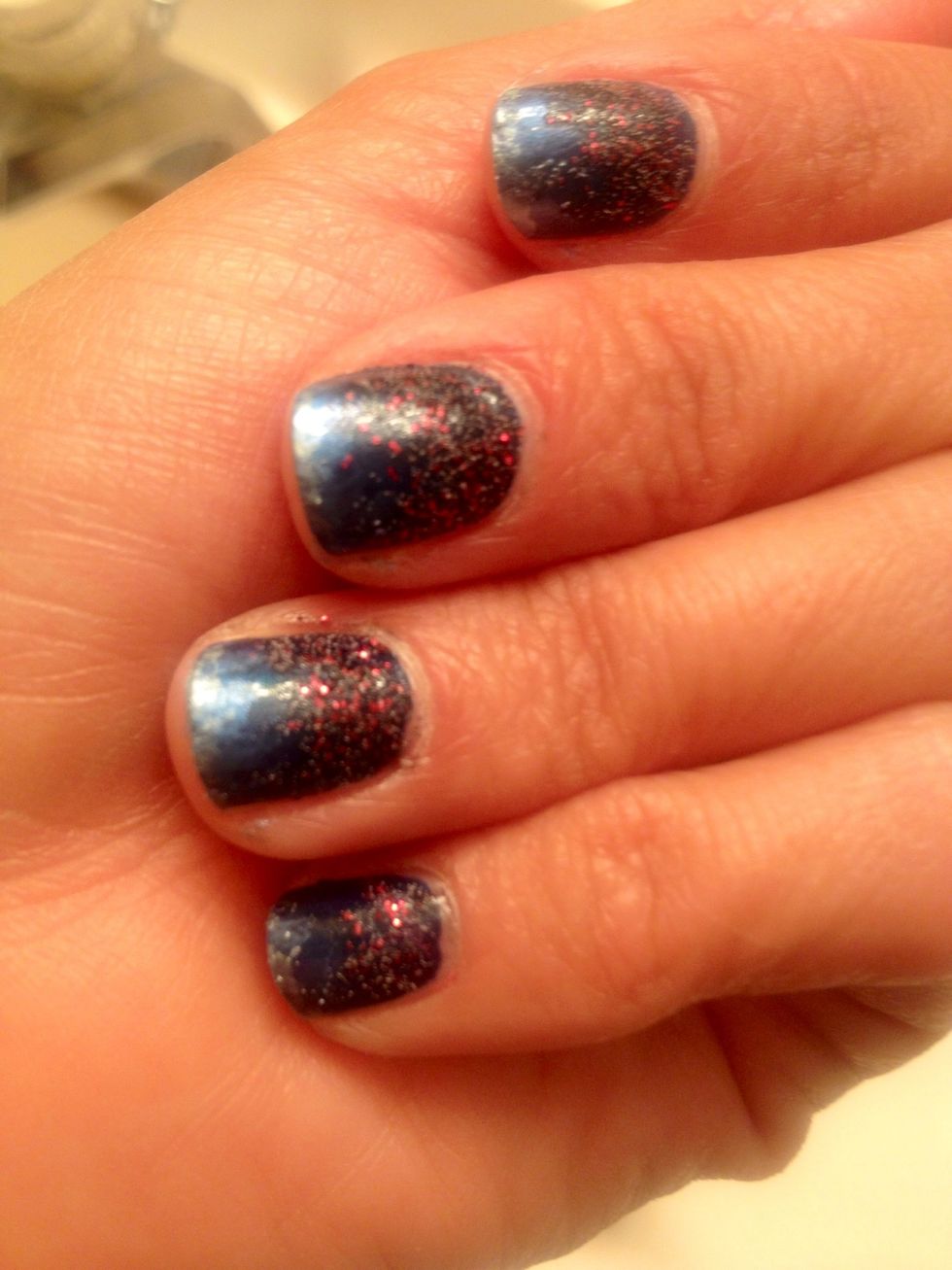 After you apply the lighter color to the tips of nails, you will want to clean up around the edges of the nails with a cotton ball and file.