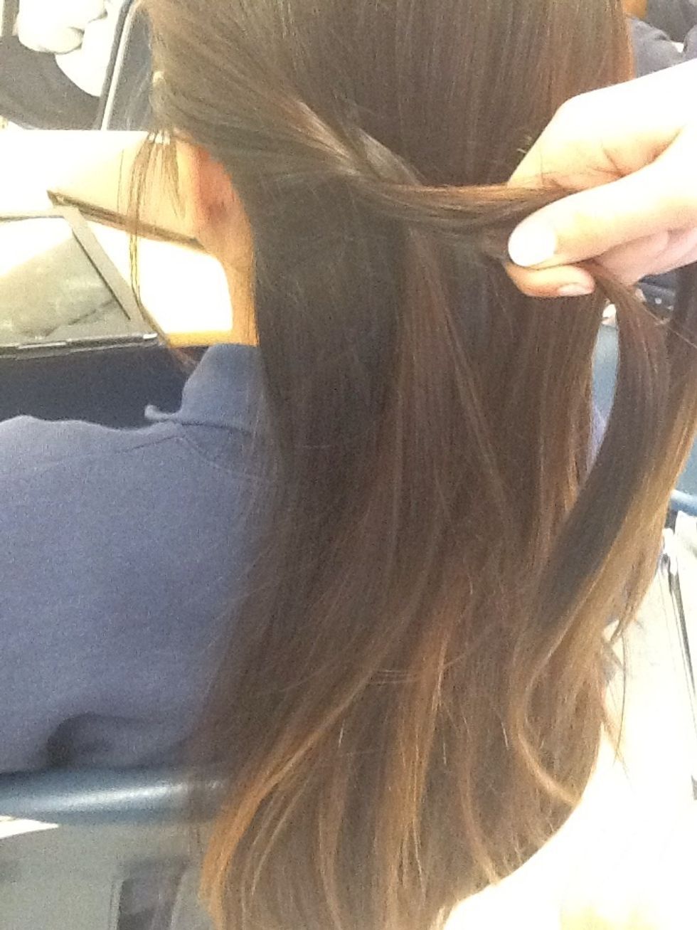 After you braided it a little, drop one piece of the braid.