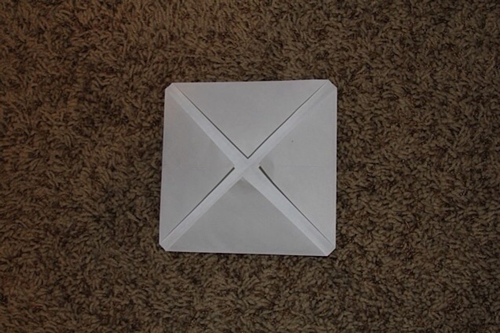 After you folded all of the corners in, it should look like this! Now flip it over :)