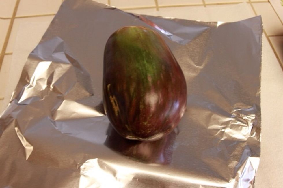 After you have a clean and dry eggplant, wrap your eggplant up with aluminum foil.