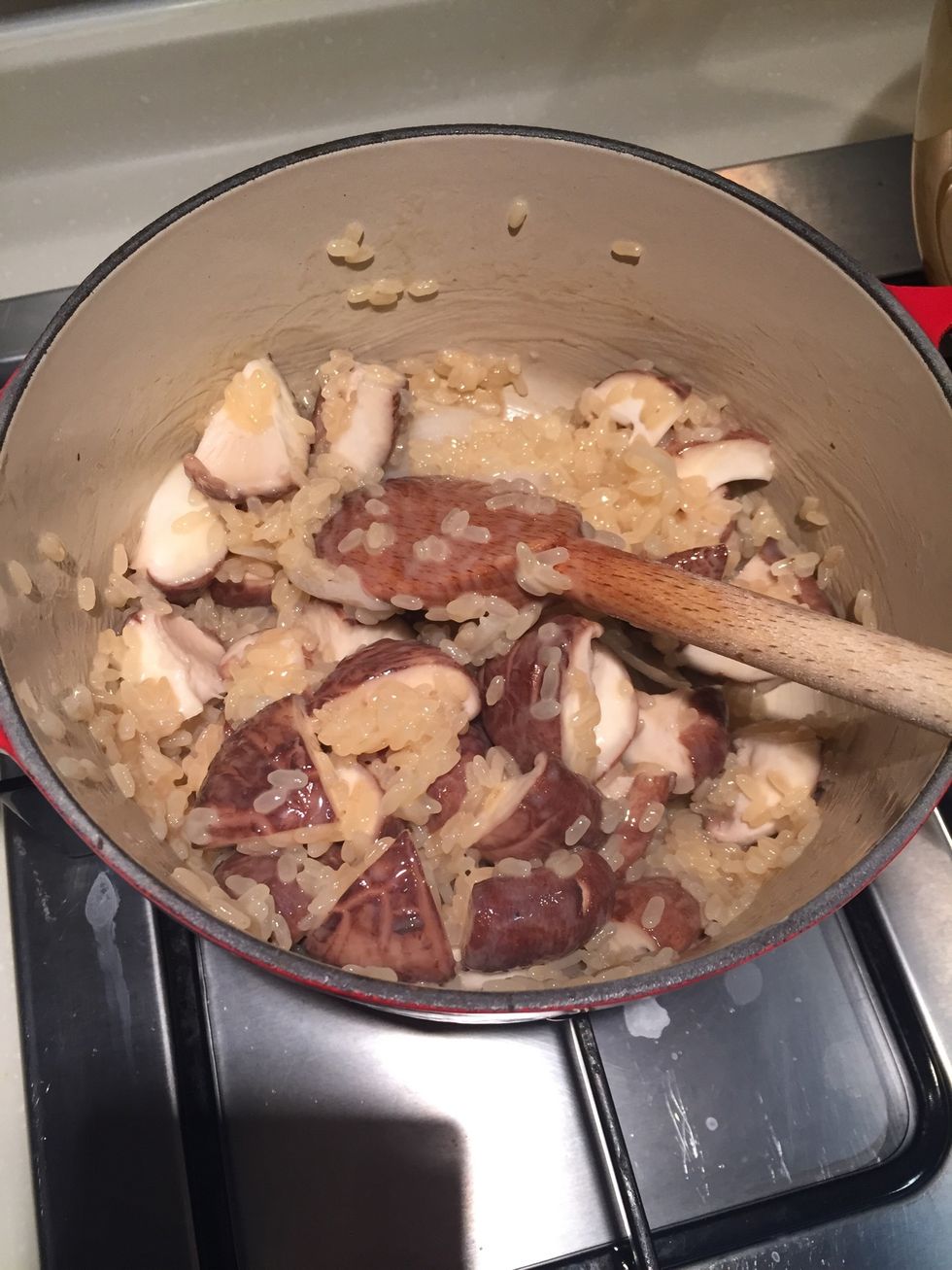 After you have cooked the risotto in the wine for a while, add the mushrooms.