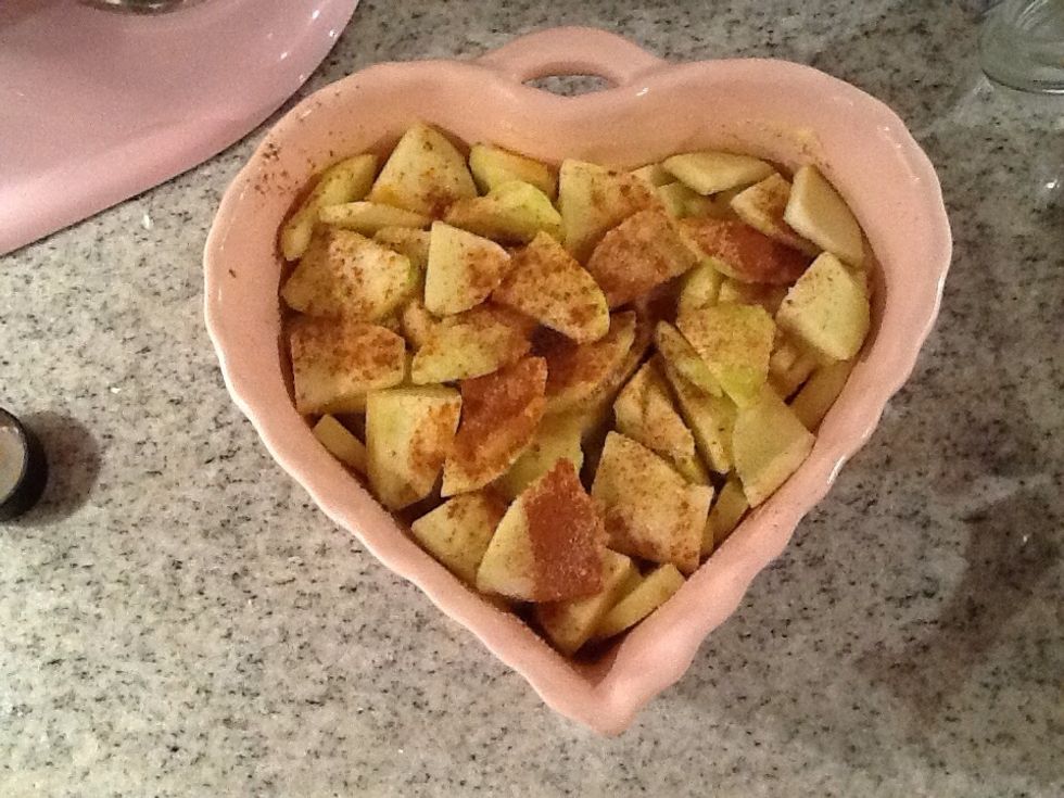 After you have done all of the apples you put them in the pie plate, and sprinkle sugar and cinnamon.