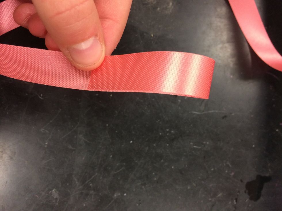 after you have finished taping the flowers together you will need to make a bow. choose your ribbon and make 1 small loop.