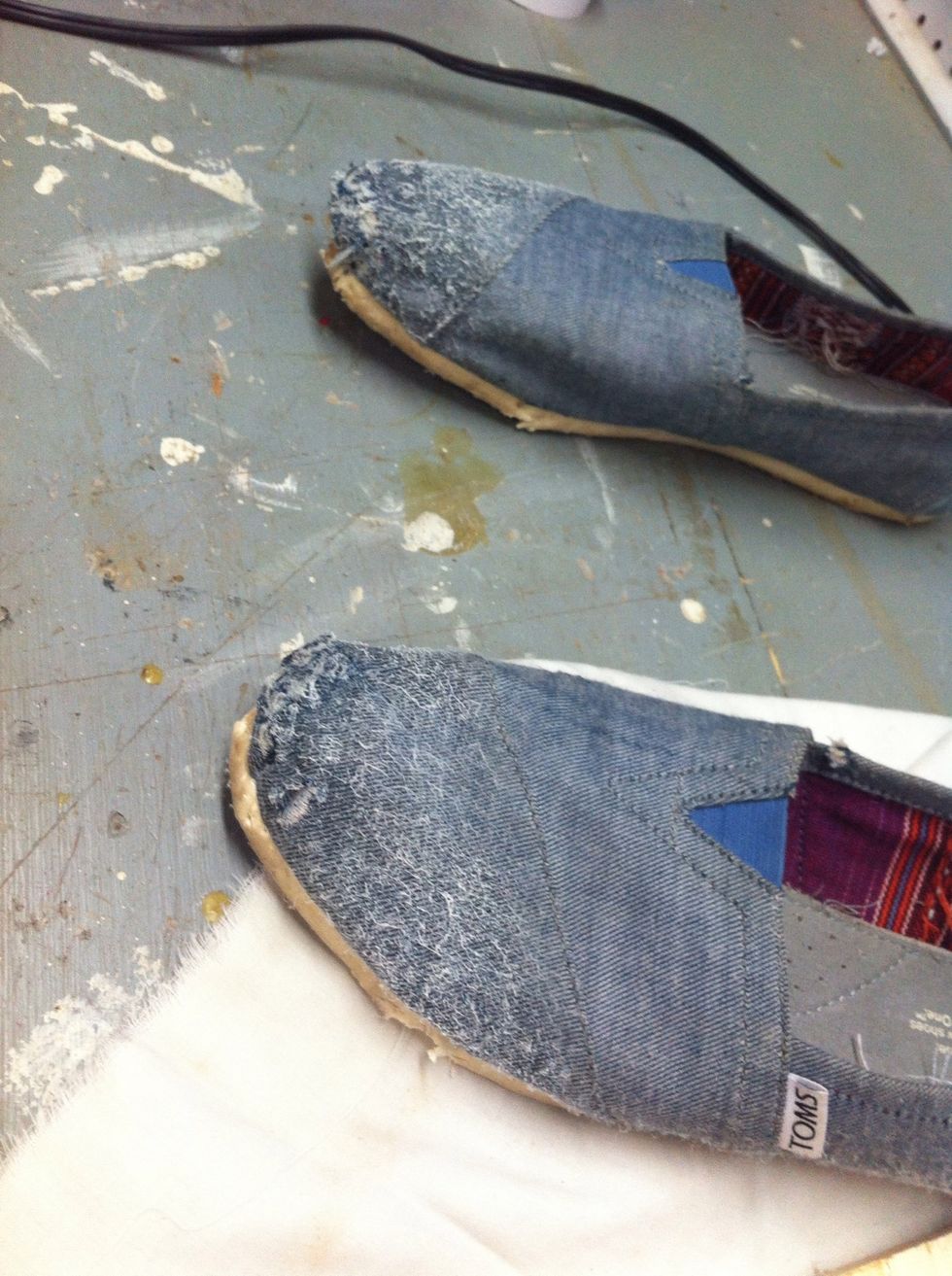 After you have sprayed the Adhesive on your shoes, add your fabric.