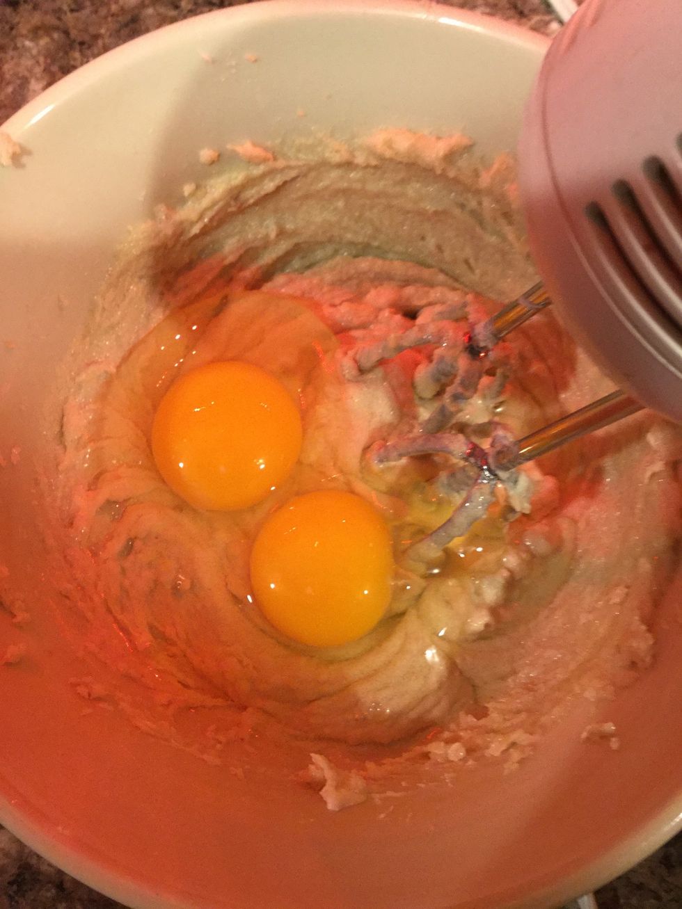After you mix the butter, granulated sugar, brown sugar and vanilla extract crack your two large eggs. Put the two large eggs into the same bowl as step five. Using your mixer mix.