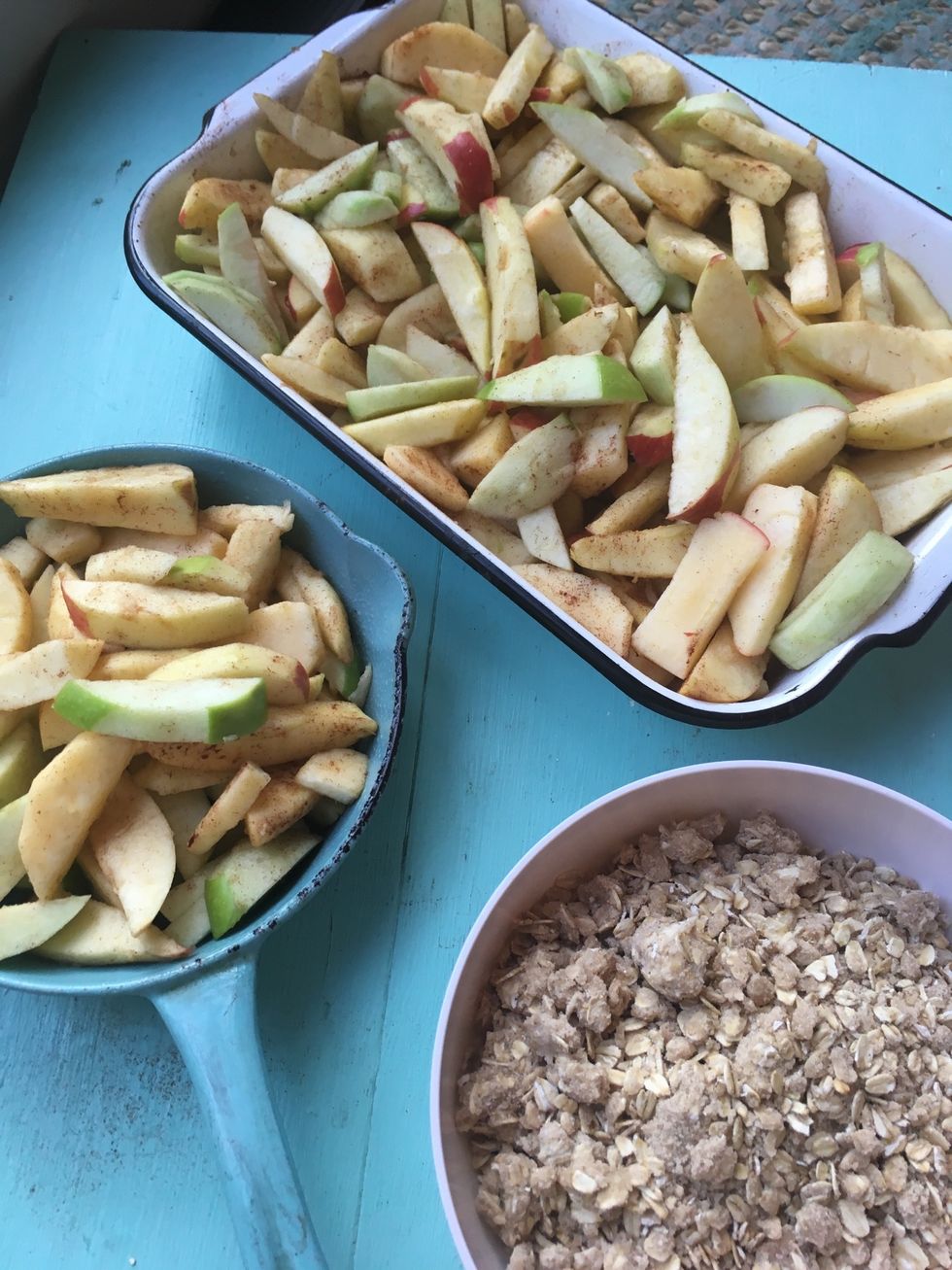 After you're done cutting and peeling the apples and they're in the pan, get out the cold oat topping you made earlier. Put the topping on the apples then put it in the oven.