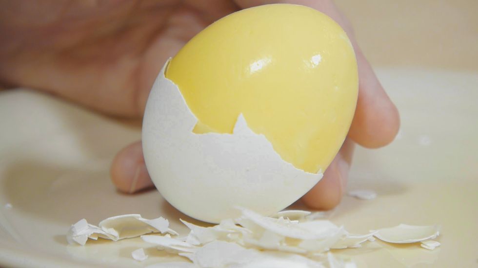 After you take the eggs out of the ice water, peel off the shells to reveal the delicious scrambled inside. Now you have an awesome treat! Enjoy
