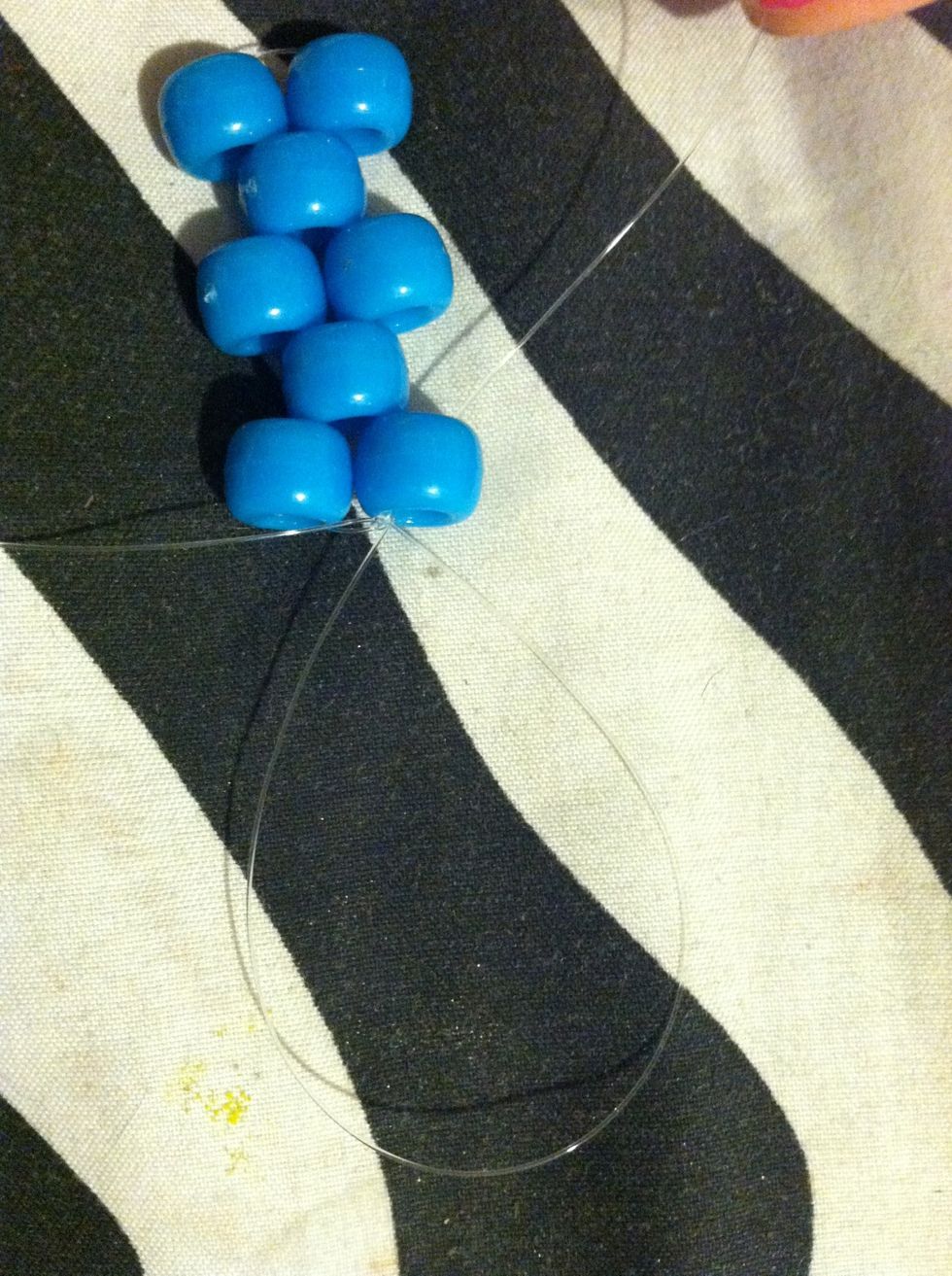 After You Tie It Off , Take One Of Your String It Doesn't Matter Which One , And String It Through That First bead .