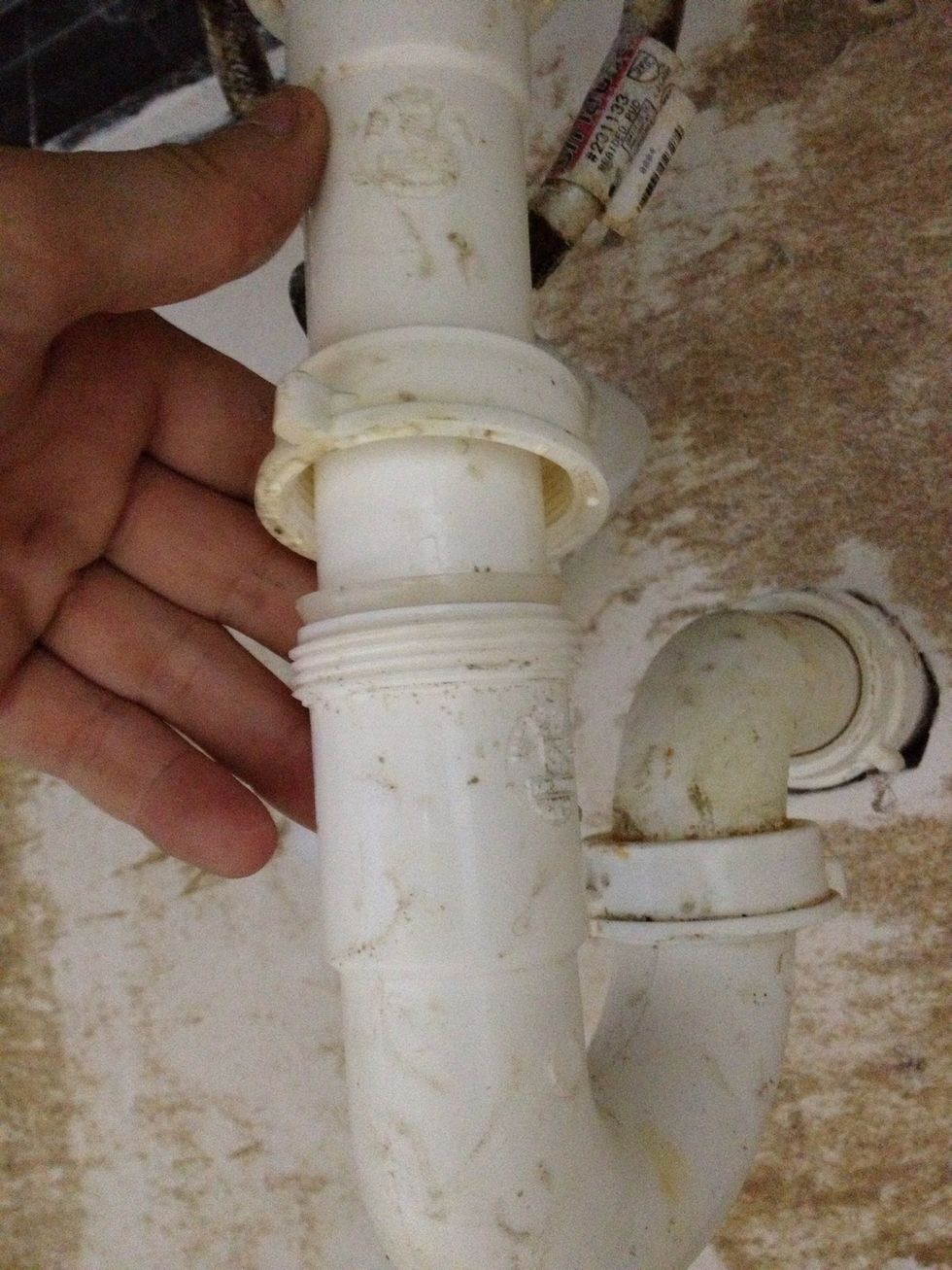After you unscrew the top fastener, it should pop up like this. Water will likely not leak out, as this end of the trap is elevated.