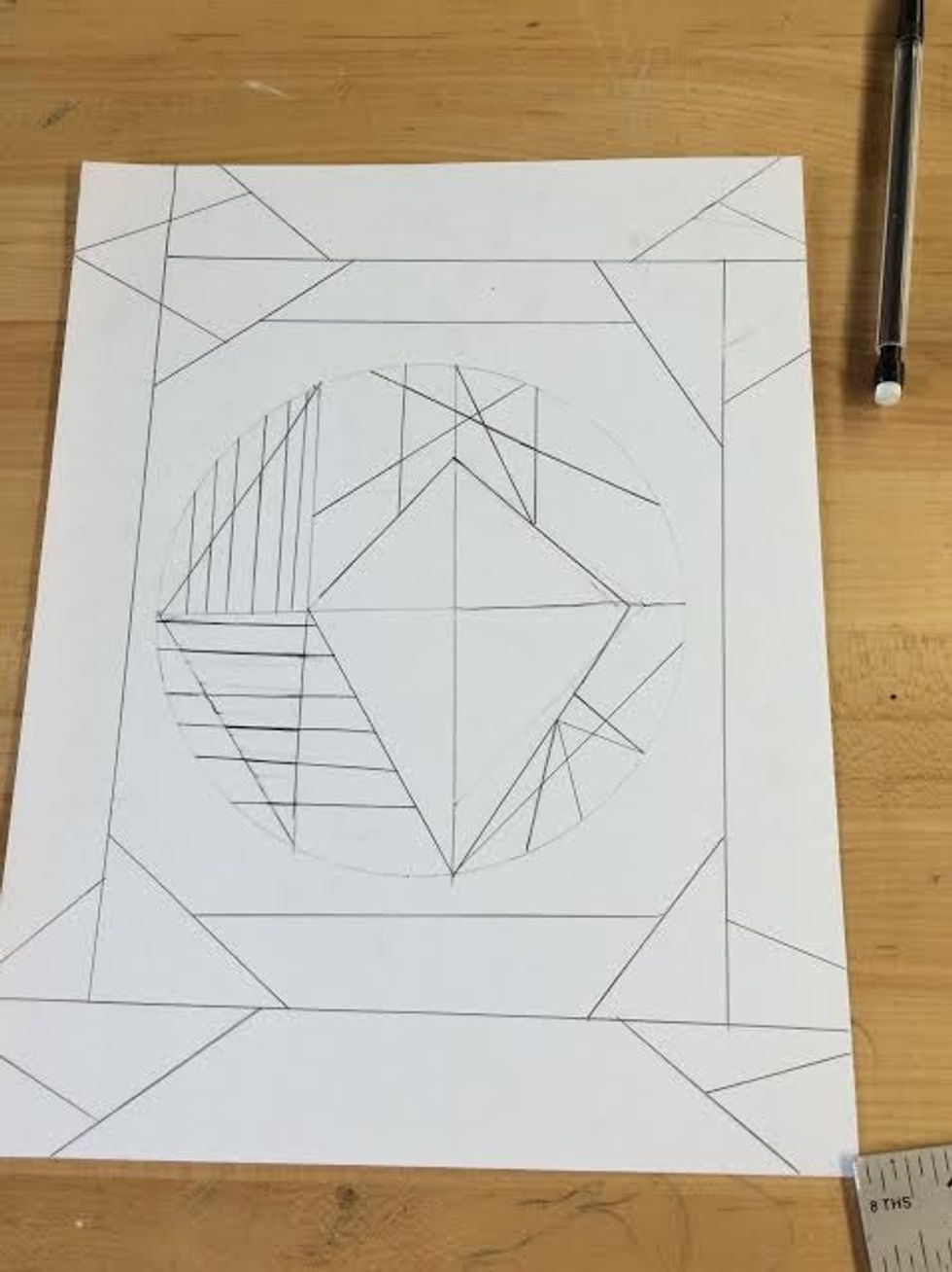 After you've finished completing your abstract lines inside the circle, you will border the outsides using a ruler and pencil which you should have already been using for the circle and shapes inside.