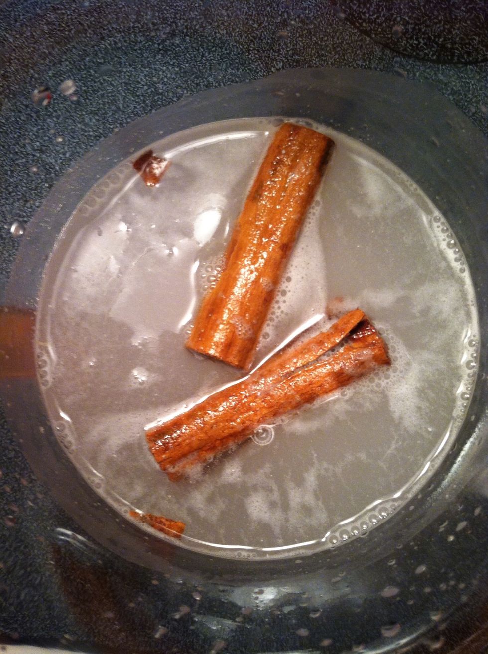 After you've grinded the rice well, place the water, rice and cinnamon in a pitcher.