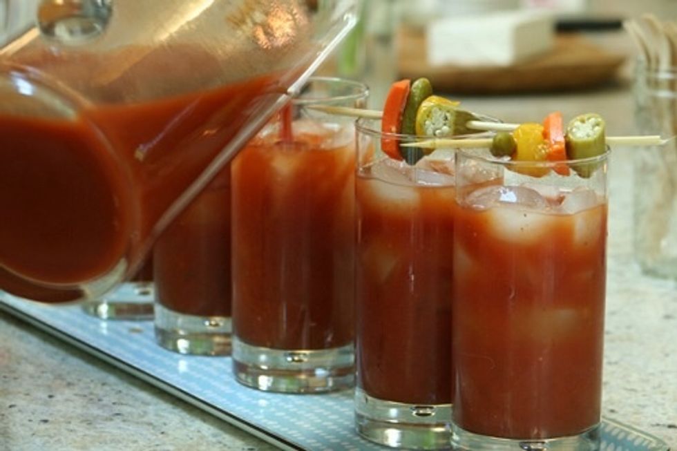 After you've mixed all ingredients, including your alcohol, pour the mix into your glass(es). Stir, and add your preferred garnishes. I use a celery stalk, olives and peppers!