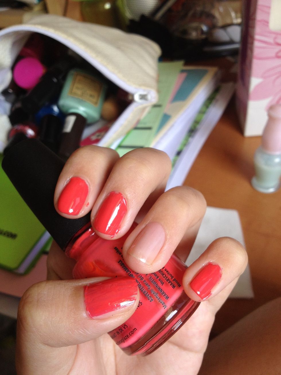 After your base coat dries, paint on your colour nail polish. Don't worry if it gets messy around the edges, we'll clean it up later. Skip the ring finger if you want to do an accent nail.