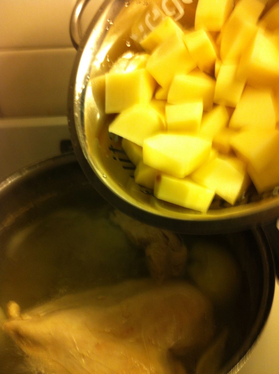 After your chicken has been boiling for about 20 minutes, strain your potatoes from the water bath and add them to the broth with the chicken. Continue on a slow boil for another 20 minutes.