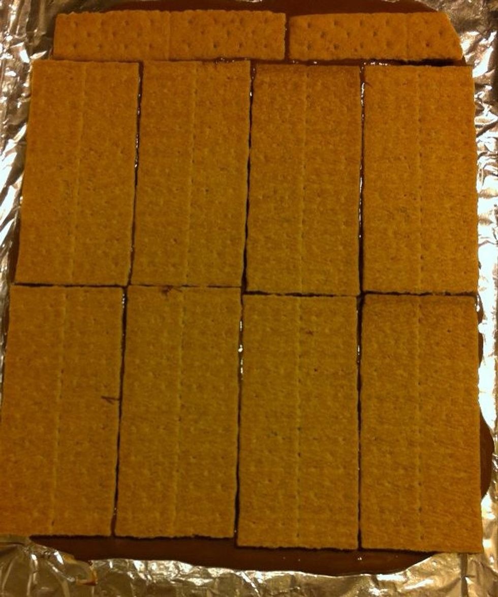 After your graham cracker layer has been set, pour your remaining chocolate over the layer and spread evenly with a spatula.