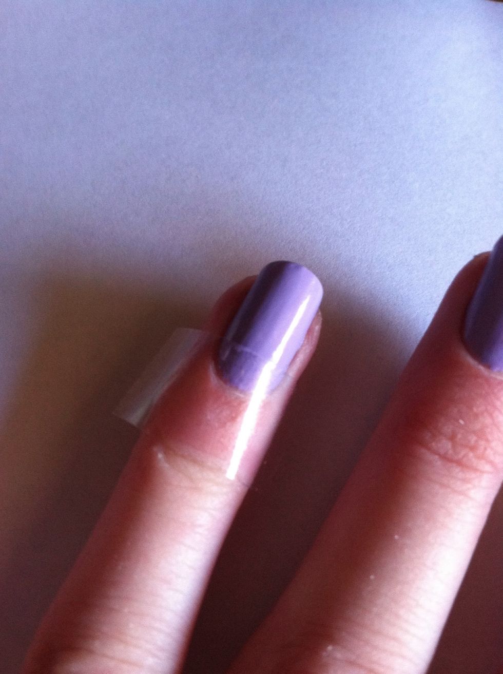 After your nails dry, place tape near your cuticle as shown in the picture.