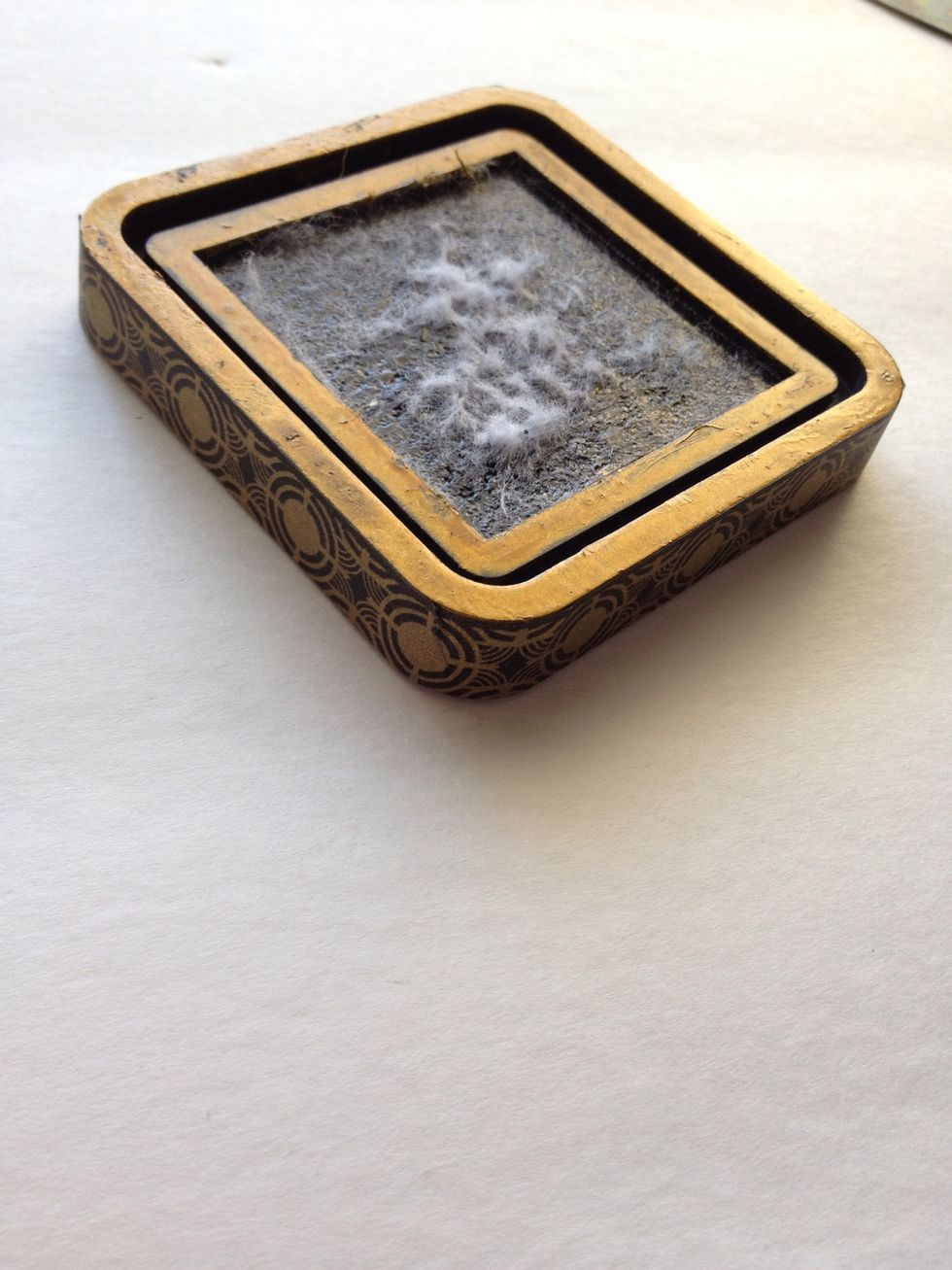After your paint has dried, attach 1/2" thick black and gold washi tape to the bottom edges of your ink pad base. For extra hold, place some adhesive behind the washi before attaching.