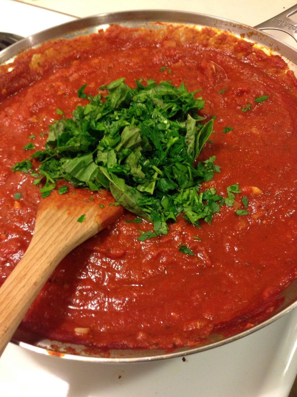 After your sauce has reduced to where you like, add the basil and 2 parts parsley. You want to add the fresh herbs at the end because they start to get bitter the longer they cook!