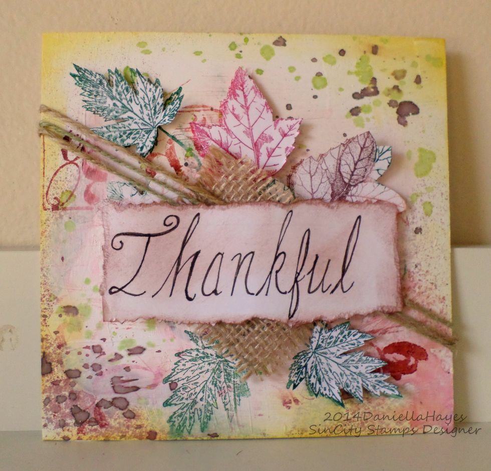 Again, adhere the cut out leaves to the stamped leaves on the block with foam dots. Add burlap and rope and put "Thankful" on top.