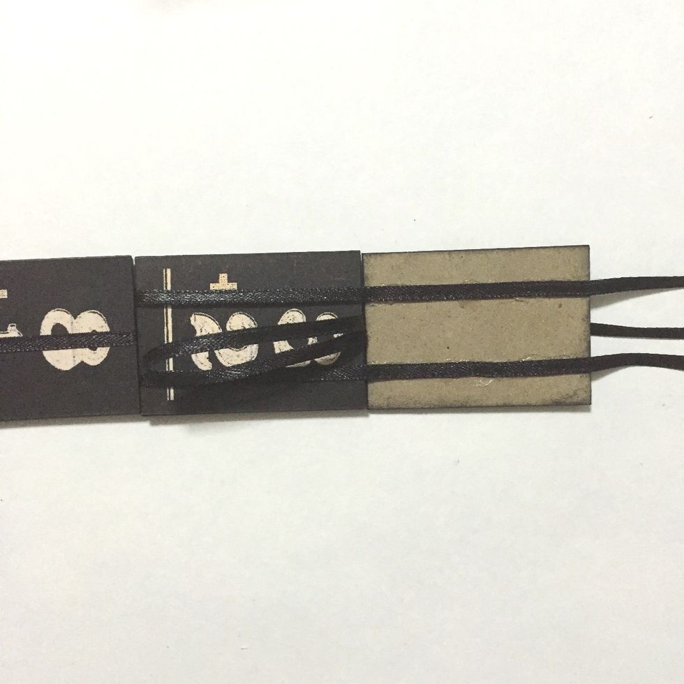 Again, create a loop by inserting the center ribbon onto the gap between the 5th and 7th number blocks as shown...