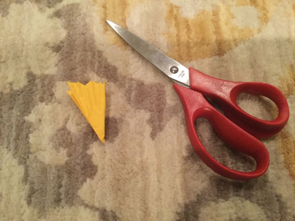 Again, cut out a petal shape at the top of the folded cupcake liner.