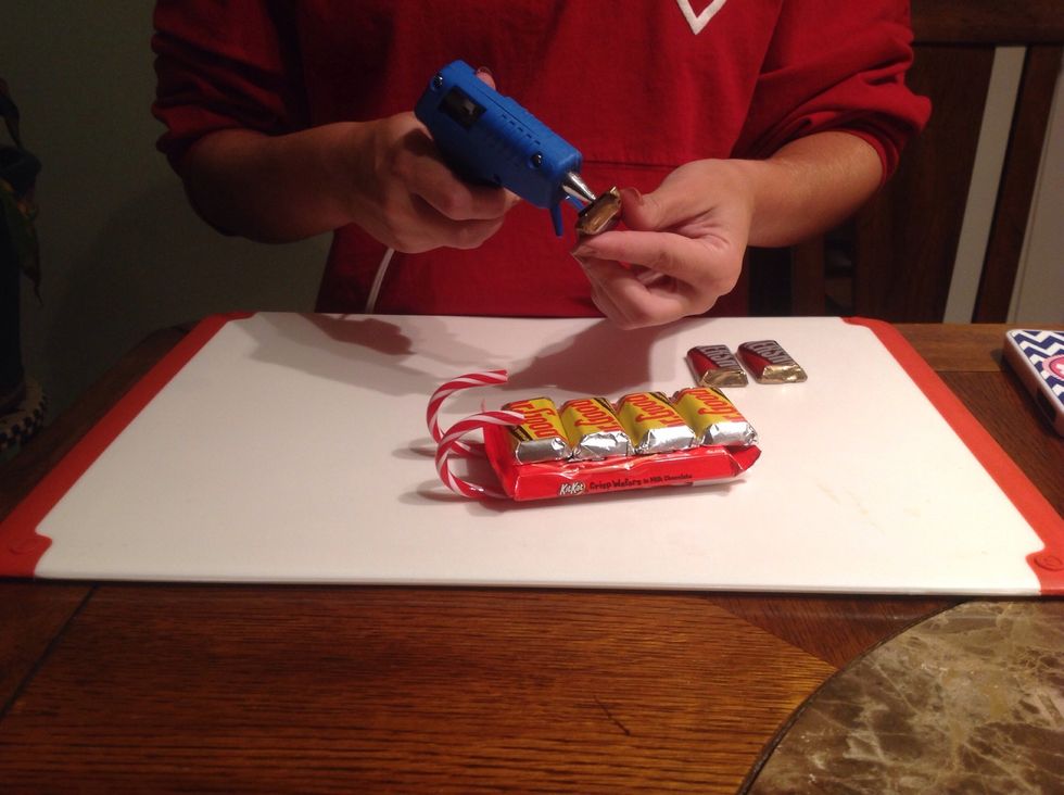 Again place drops of hot glue on the three Hershey's dark chocolate bars and set them in between the spaces of the Mr. Goodbars.